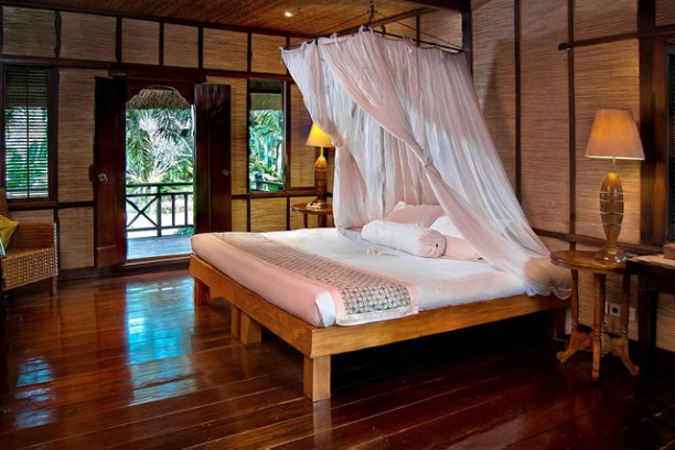 a bed with a wooden floor