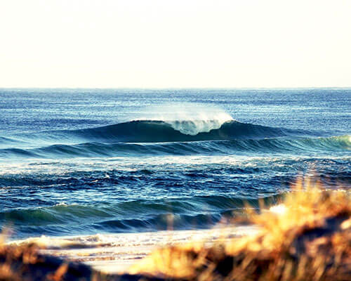 a man riding a wave on a surfboard in the ocean