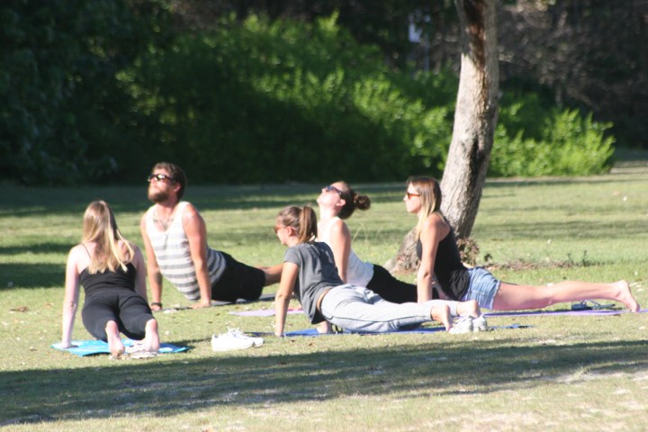 a group of people playing frisbee in a park