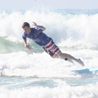 a man riding a wave on a surfboard in the ocean