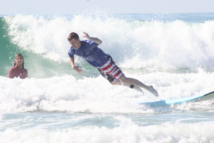 a man riding a wave on a surfboard in the ocean