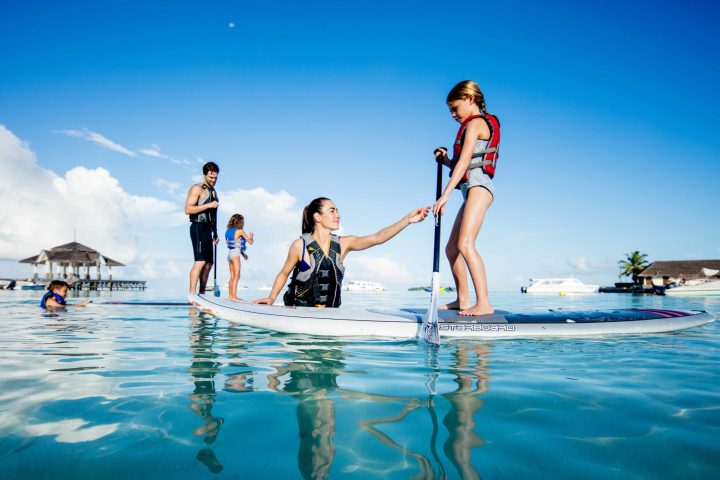 a group of people that are standing in the water