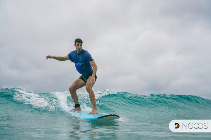 a person riding a wave on a surfboard in the ocean
