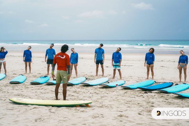 a group of people sitting at a beach