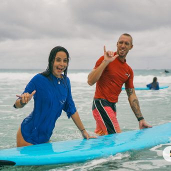 a girl riding a wave on a surfboard in the ocean