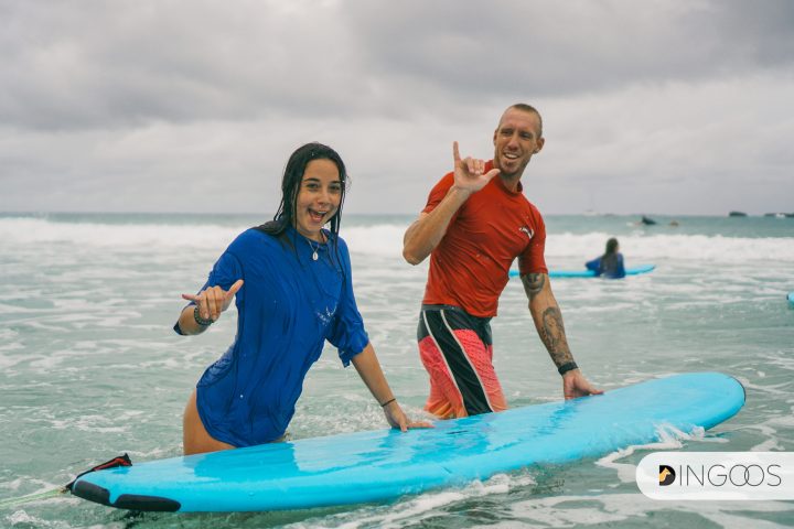 a girl riding a wave on a surfboard in the ocean