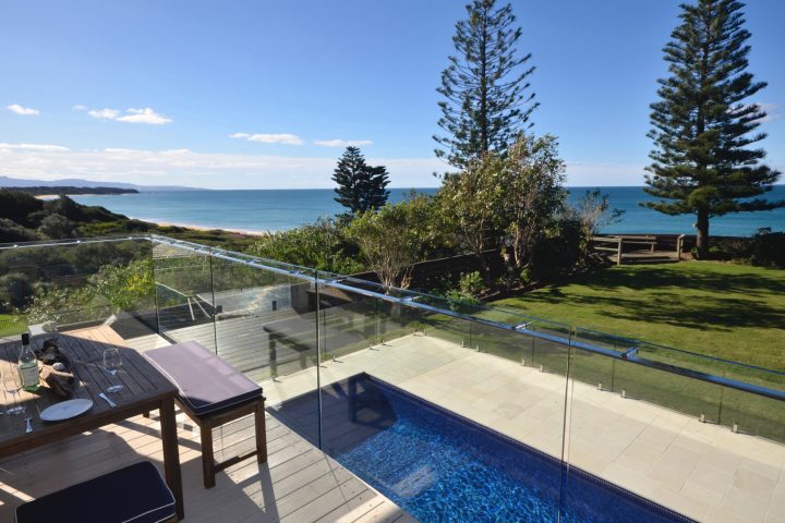 a close up of a bench overlooking a body of water