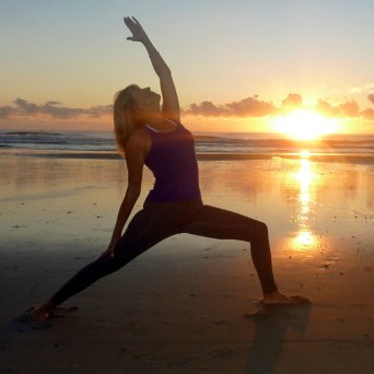 a person standing on a beach near a body of water