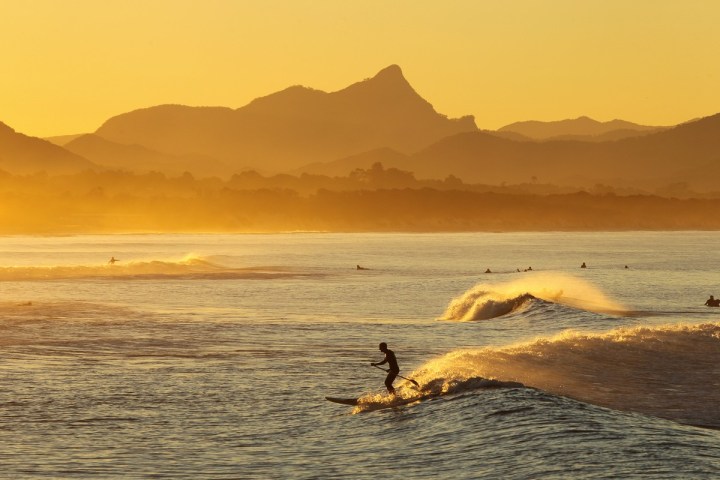 a body of water with a mountain in the background