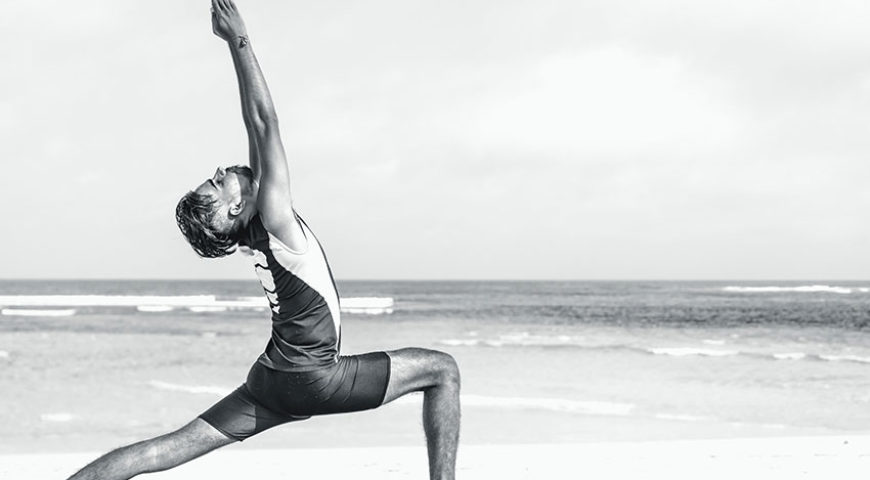 surf-yoga01-870×480 a person throwing a frisbee at the beach
