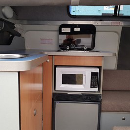 a microwave oven sitting on top of a stove