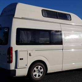 a white bus parked in a parking lot