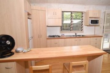 a kitchen with wooden cabinets and a window