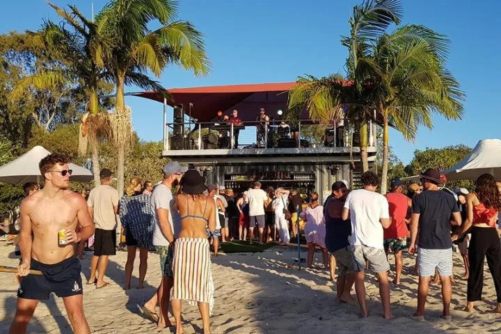 a group of people walking on a beach