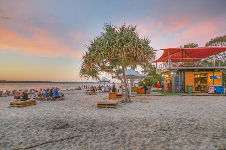 a boat sitting on top of a sandy beach
