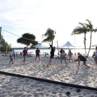 a group of people walking on a beach